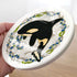 EarthArt International ceramic Orca whale coaster with floral and fish border. Black, white, yellow, blue, green.