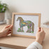 EarthArt International Wild Horse art print by Sue Caccia, featuring a colorful, detailed horse silhouette filled with nature motifs and a foal inside.